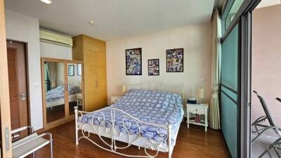 Spacious bedroom with large windows and balcony access