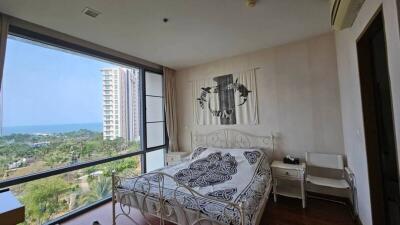 Bedroom with large window and a sea view