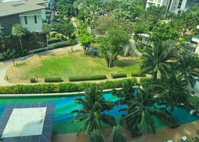 Aerial view of residential buildings with lush greenery and a swimming pool