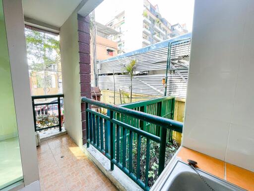 View from balcony with railings and nearby buildings