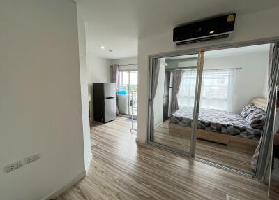 Bedroom and hallway view with sliding glass doors and air conditioning unit