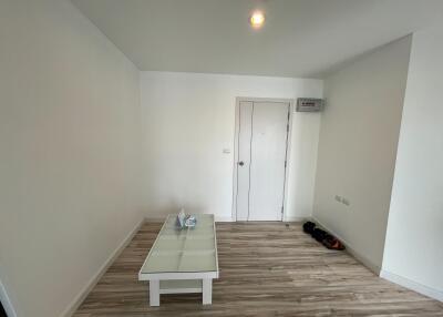 Minimalist living room with wooden floor and white coffee table