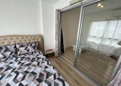 Bedroom with sliding glass doors and view into adjacent room