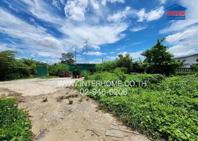 Vacant land with greenery and clear blue sky