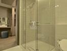 A modern bathroom with glass shower enclosure and vanity area