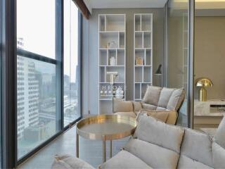 Modern living room with large windows and comfortable seating