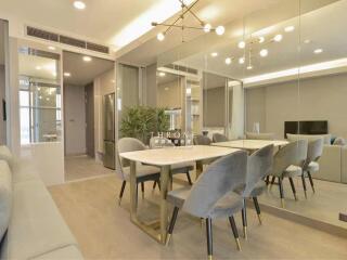 Modern dining area with stylish furniture and a large mirror