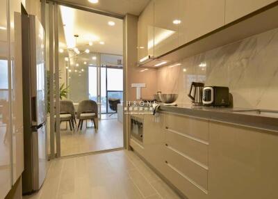 Modern kitchen with appliances and view into dining area
