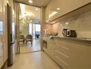 Modern kitchen with appliances and view into dining area