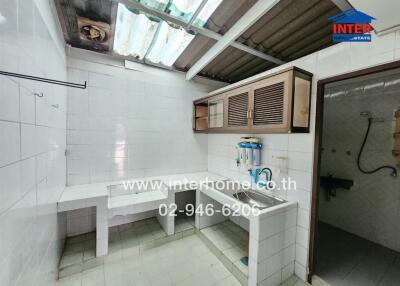 Simple kitchen with tiled walls and counters