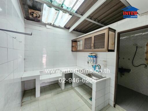 Simple kitchen with tiled walls and counters