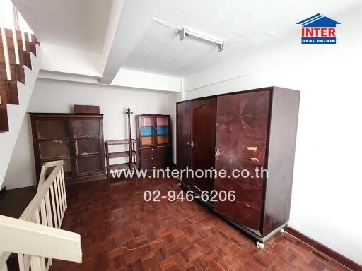 Interior space with wooden floor and multiple cabinets
