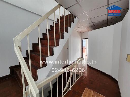 Staircase area with wooden steps and railing in a house