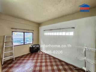 Unfurnished room with a window, tiled floor, and a ladder