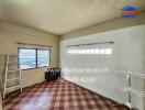 Unfurnished room with a window, tiled floor, and a ladder