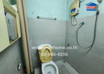 Small bathroom with tiled walls and shower