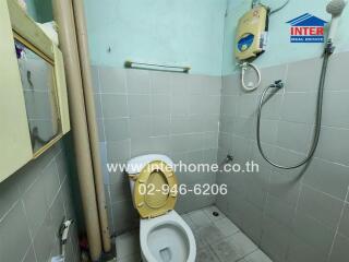 Small bathroom with tiled walls and shower