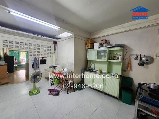 A kitchen with various appliances, storage units, and cooking equipment.