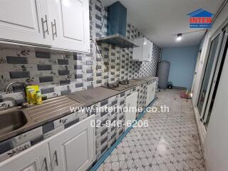 Modern kitchen with tiled backsplash and stainless steel appliances