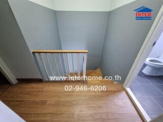 Staircase with wooden steps and a bathroom