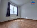 Empty bedroom with wooden floor and a window curtain