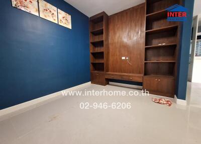 Empty room with built-in wooden shelves