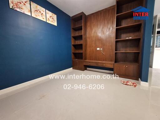 Empty room with built-in wooden shelves