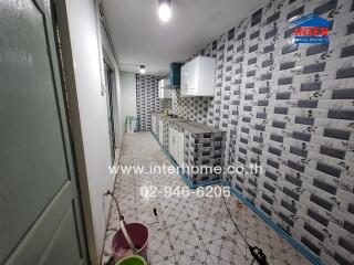 Long kitchen with tiled floor and wall-mounted cabinets