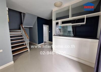 Living area with stairway and built-in counter