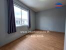 Bedroom with wooden floor and large window