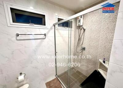 Modern bathroom with a shower and tiled walls