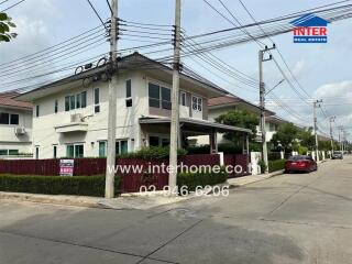 Residential building exterior with driveway and surrounding area