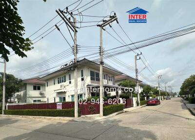 Street view of residential area with houses and electrical poles