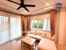 Cozy, well-lit living room with a ceiling fan and sectional sofa.