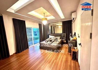 Spacious bedroom with modern decor and wooden flooring