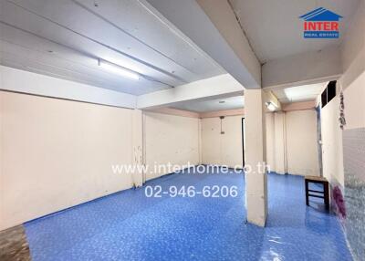 Unfurnished living area with blue flooring