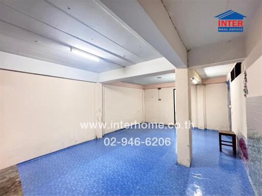 Unfurnished living area with blue flooring