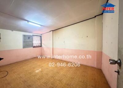 Empty room with wooden floor and a window