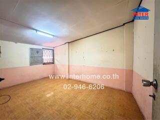 Empty room with wooden floor and a window