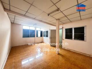 Unfurnished living space with tiled floors and windows