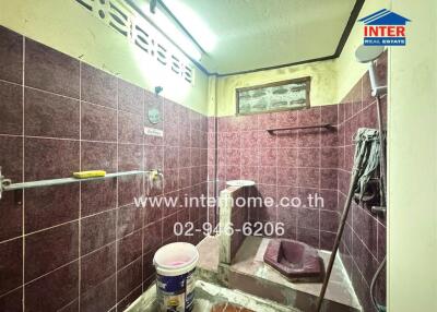 Bathroom with tiled walls and a shower area