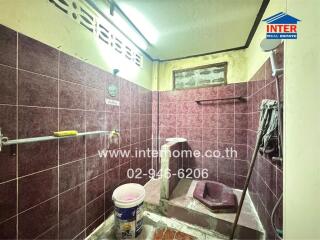 Bathroom with tiled walls and a shower area