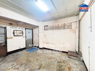 Spacious room with concrete floor and white walls