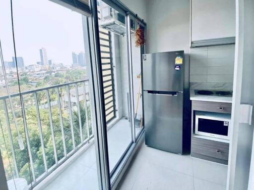 Modern kitchen with appliances and balcony view