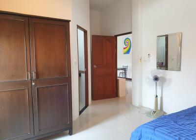 Spacious bedroom with a wardrobe, wall mirror, and access to the ensuite bathroom