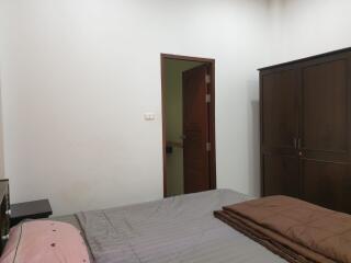 Bedroom with bed, wardrobe, and an open door