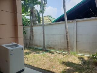 Outdoor space with washing machine and trees