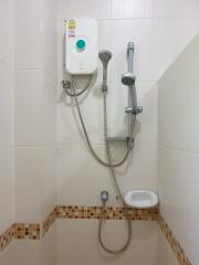 Shower area with water heater and shower fixtures