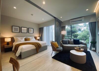 Modern bedroom with large windows and sitting area