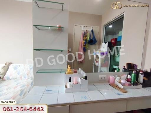 Bedroom with glass shelves and a vanity area